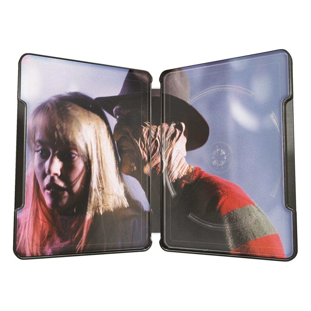Open steelbook case of A Nightmare On Elm Street featuring Freddy Krueger behind a woman with blonde hair, interior artwork with dark and eerie tones