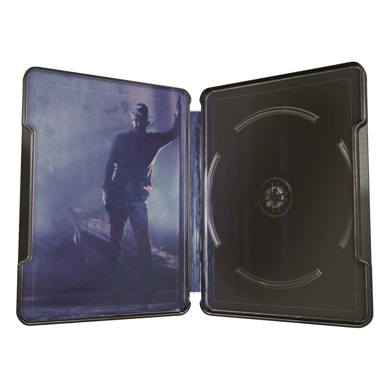 Open steelbook case featuring shadowy image of Freddy Krueger from A Nightmare On Elm Street with empty disc holders inside
