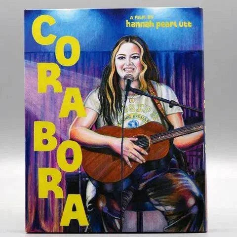 Cora Bora Blu-Ray with slipcover featuring illustrated musician with guitar, directed by Hannah Pearl Utt.