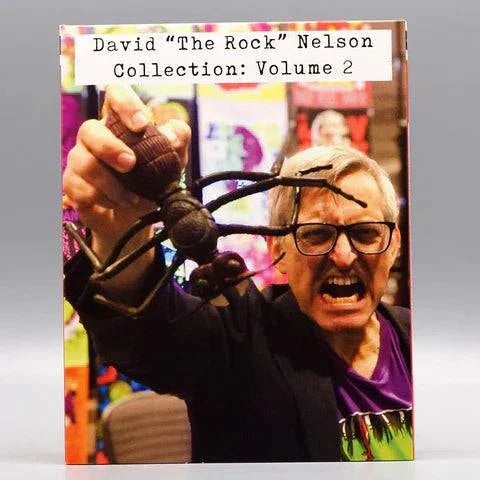 Saturn's Core - David "The Rock" Nelson Collection: Volume 2 Blu-Ray cover with slipcover featuring an enthusiastic individual holding a rubber monster prop.
