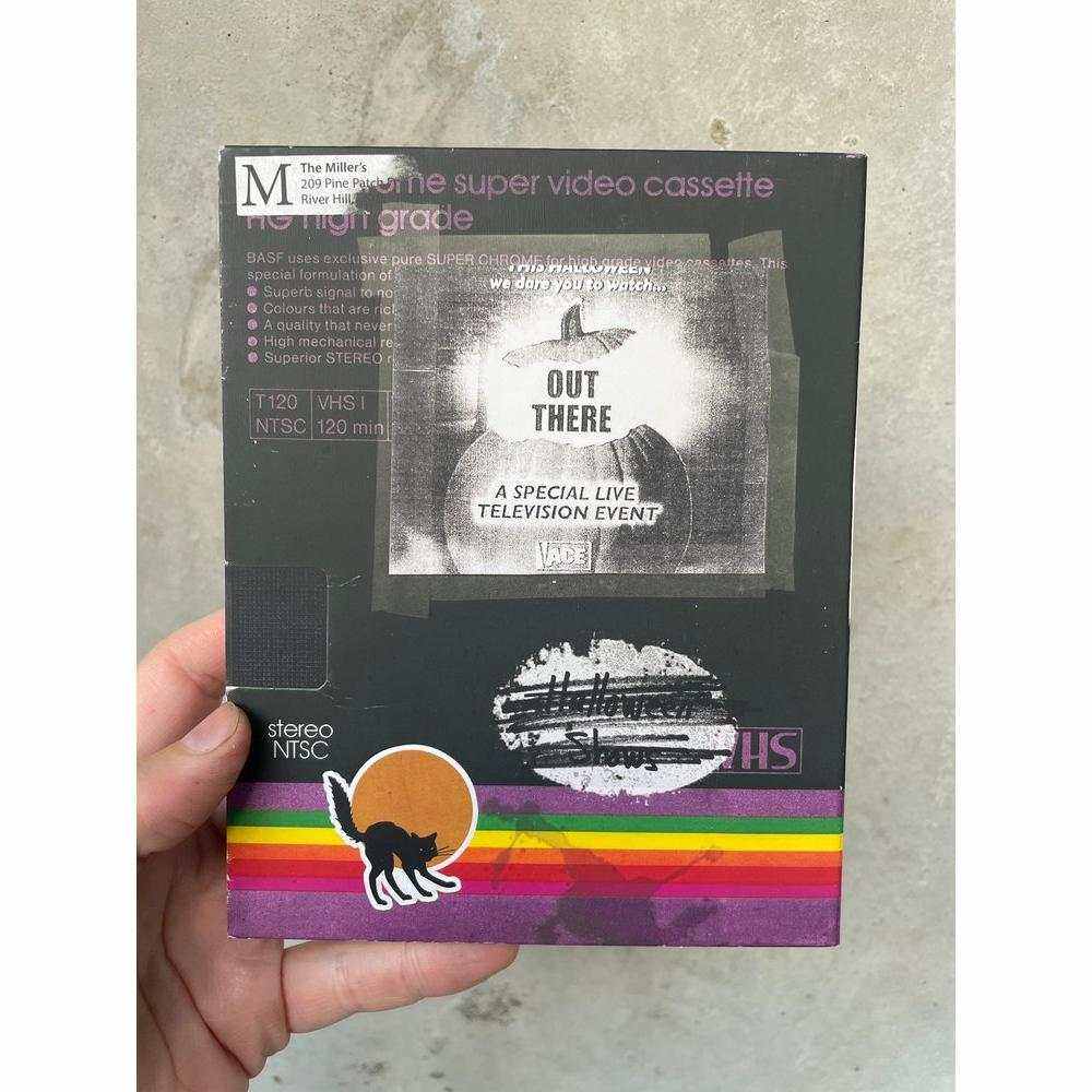 WNUF 2 aka the Out There Halloween Mega Tape Blu-Ray with slipcover held in hand, featuring retro VHS style design.