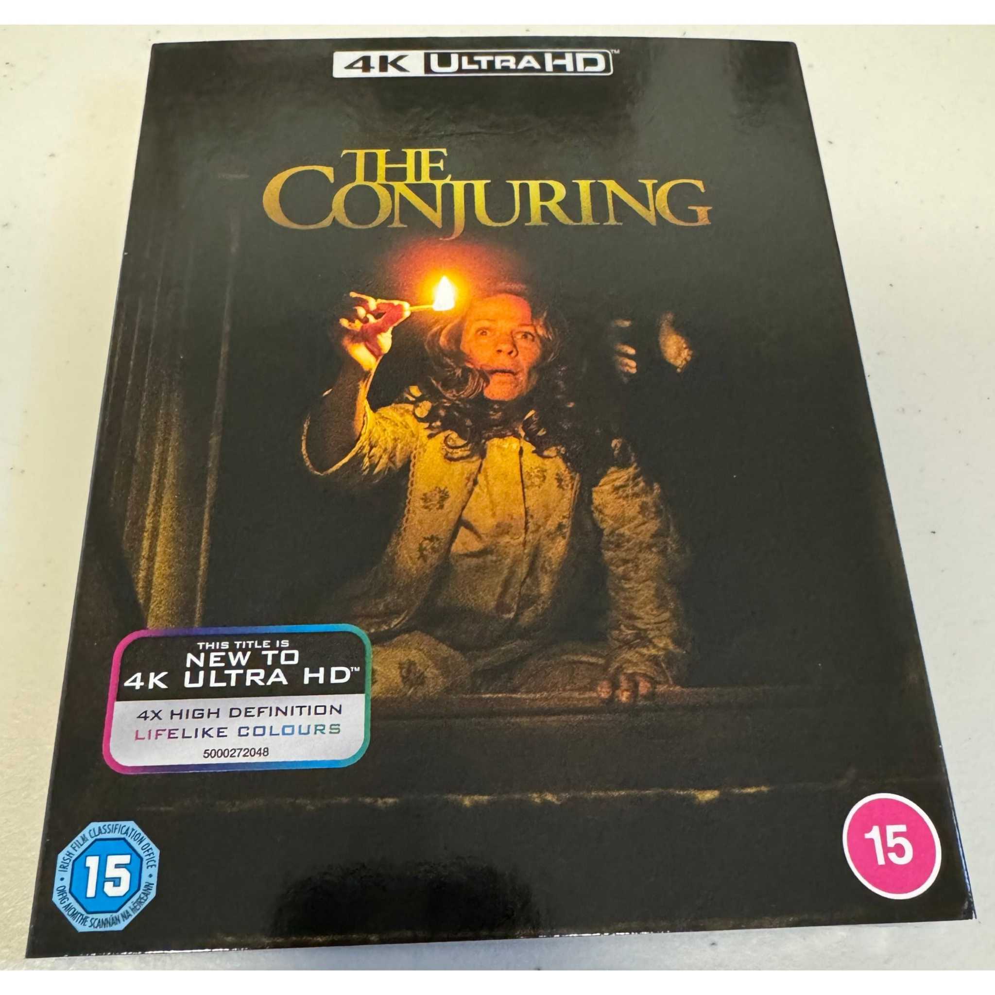 The Conjuring 4K Ultra HD movie in UK standard amaray case with slipcover featuring a scared woman holding a candle on the cover