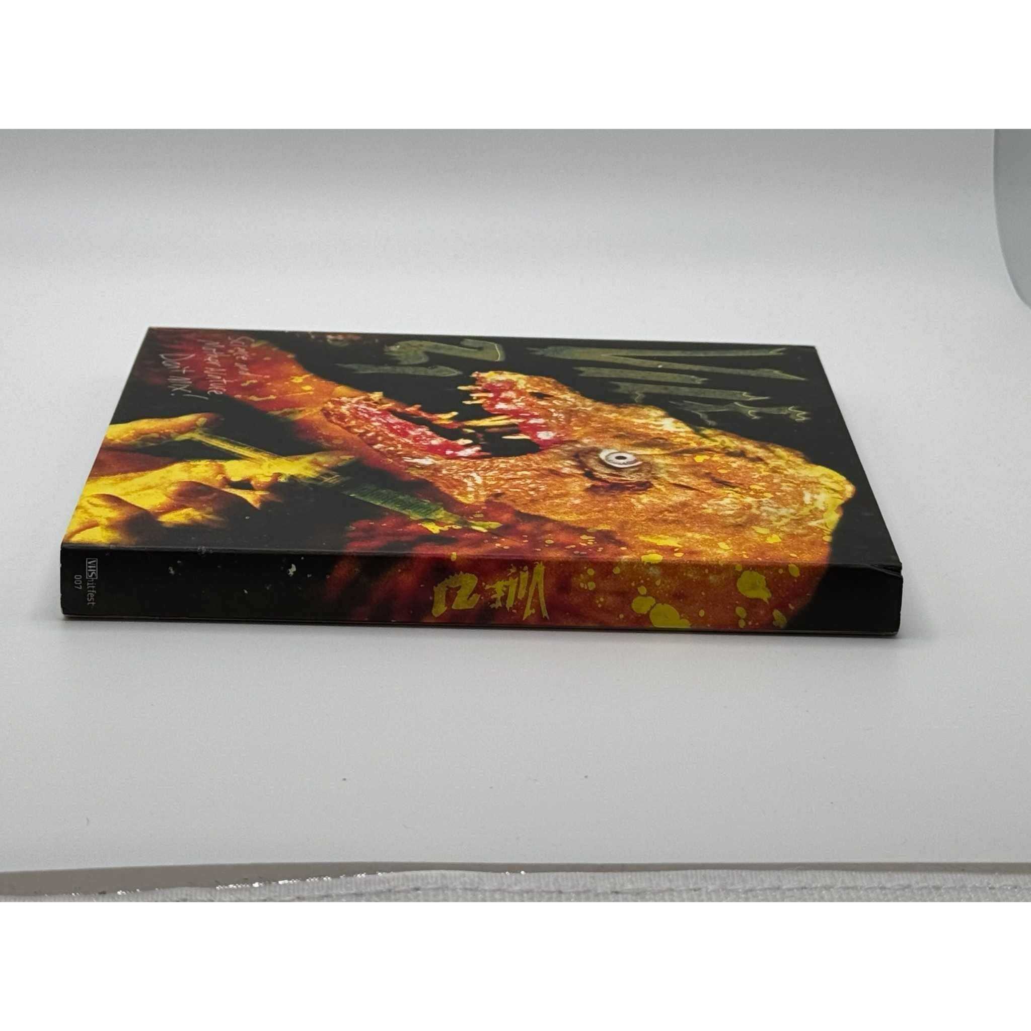 Used Vile 21 Blu-Ray with slipcover showing minor wear; horror satire film.