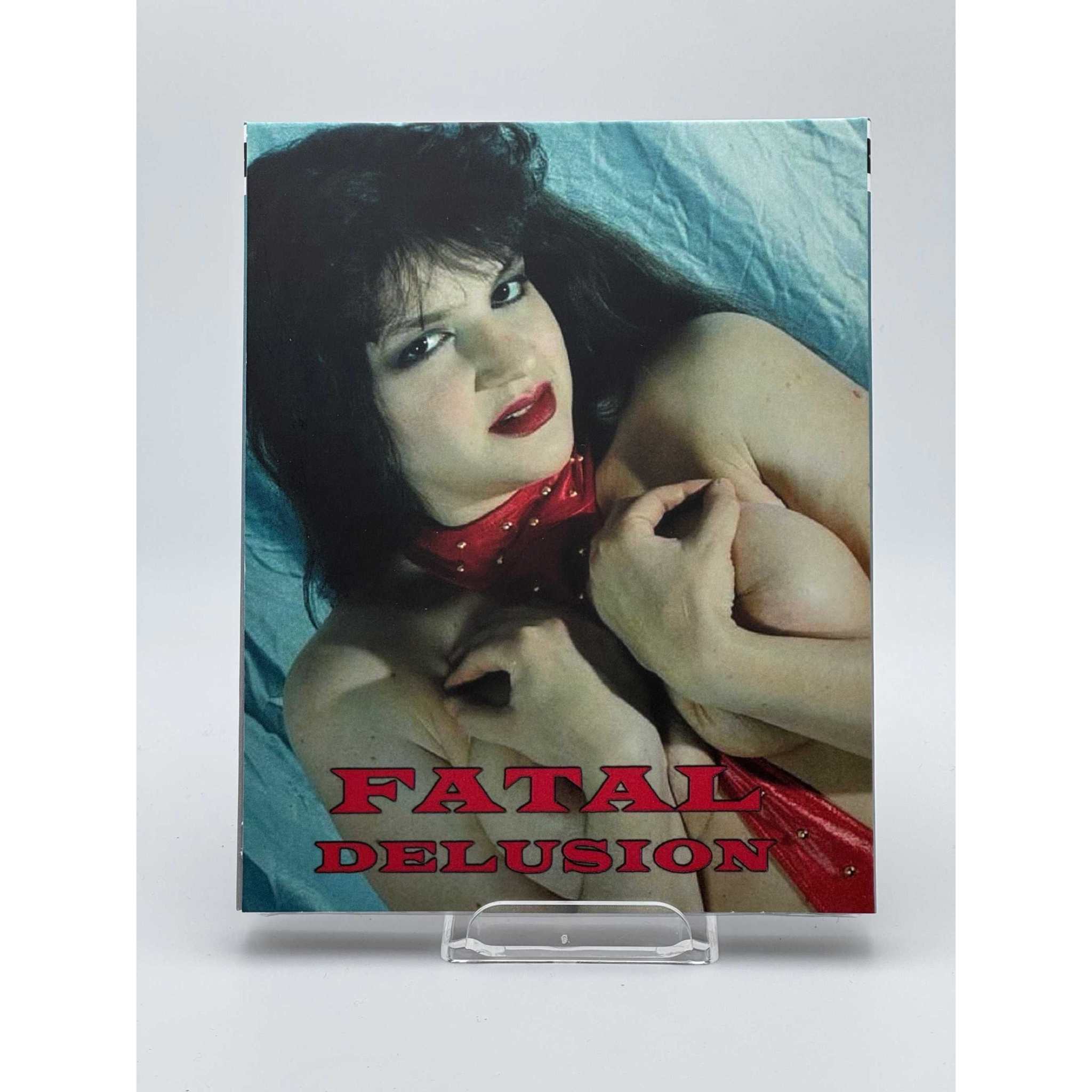 Saturn's Core Fatal Delusion Blu-Ray slipcover featuring woman with dark hair and red tie on cover