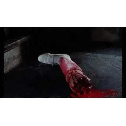 Bloodied severed arm in a horror scene from "Rabid Grannies" film on Blu-Ray.