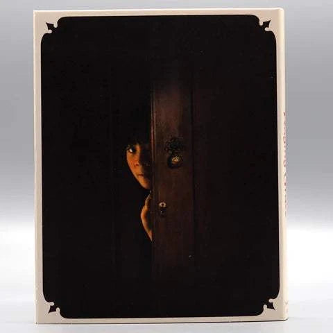 Raging Grace Blu-Ray slipcover featuring a dark, suspenseful image of a person peeking from behind a partially open wooden door.