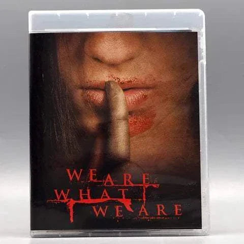 We Are What We Are Blu-Ray cover showing a close-up of a person's mouth with a finger pressed against lips, blood smudges, and red title text.