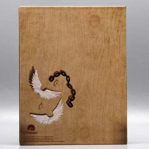 We're No Angels Blu-Ray with artistic slipcase featuring wings and shackle design on wooden texture background