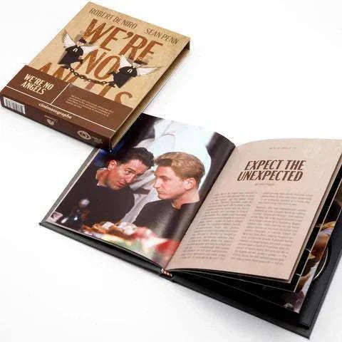 We're No Angels Blu-Ray with slipcase and open booklet featuring movie scenes and text.