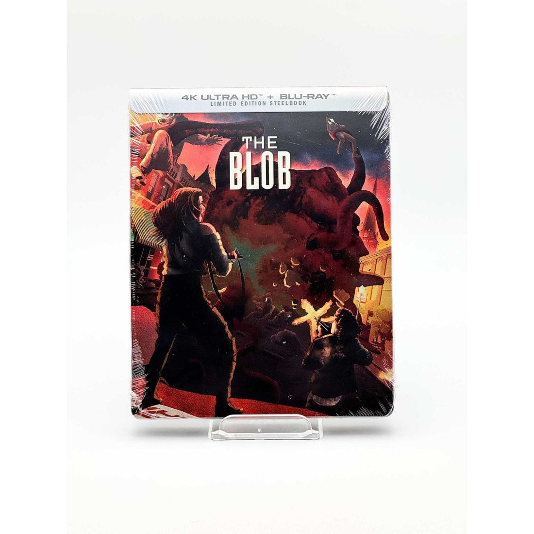 The Blob 4K UHD limited edition steelbook cover showing characters battling a giant red tentacled creature in a small town at night