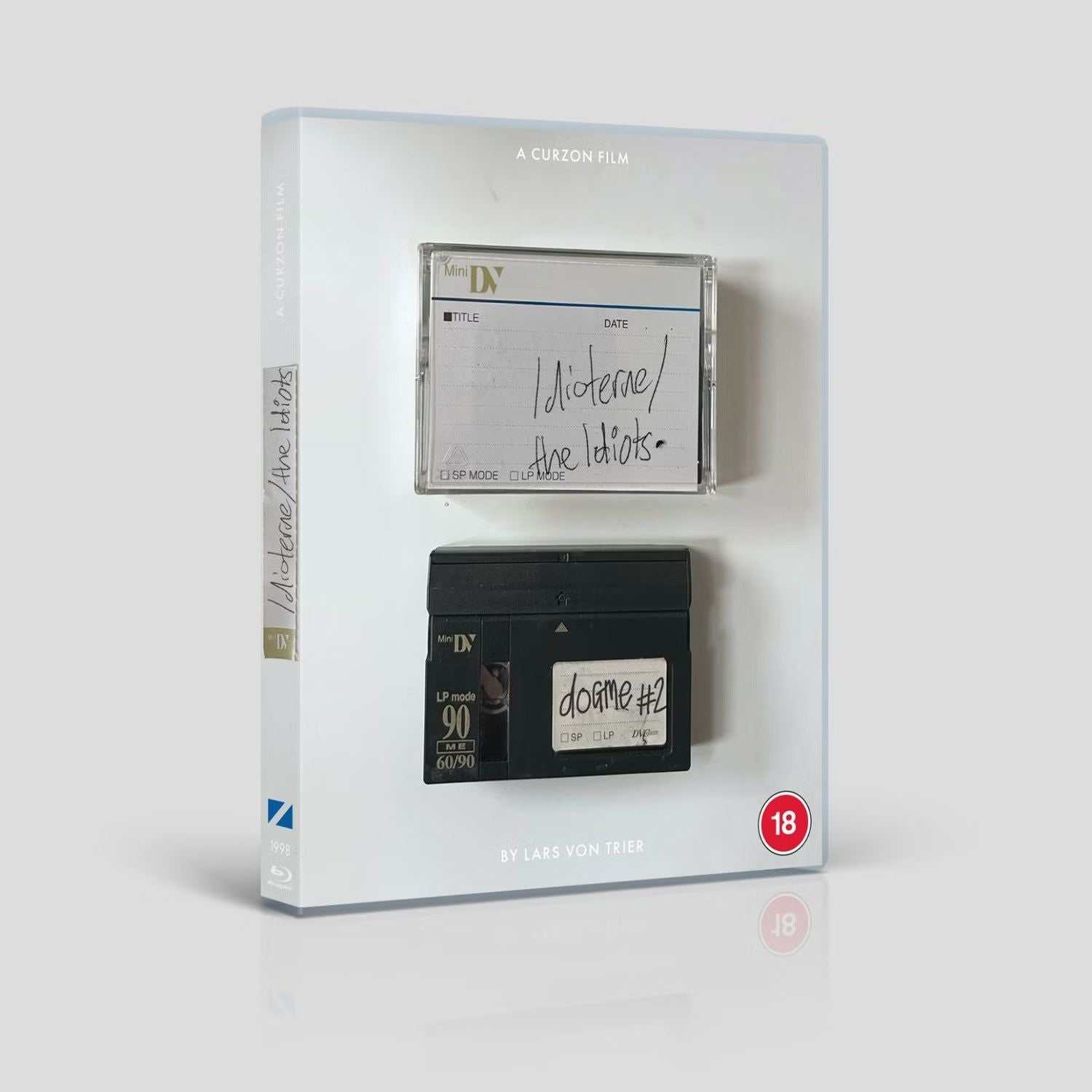 The Idiots Blu-Ray (Curzon Film World) Region B packaging featuring film visuals and age rating.