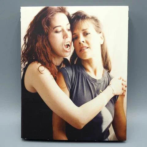 Blu-Ray cover art for Saturn's Core - Red Lips, featuring two women in an embrace, one appearing as a vampire.