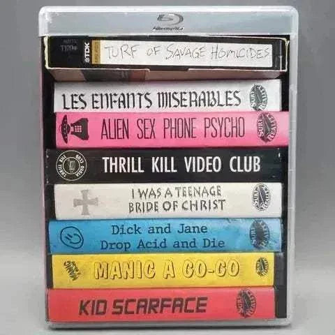 Blu-ray collection of Surf Reality Movie of the Month Club featuring vibrant, retro video cases, including titles like "Kid Scarface" and "Manic A Go-Go".